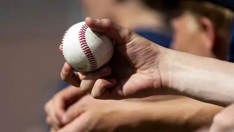 A player holds a ball during a high school baseball game held at Mountain Ridge High School in Herriman on Wednesday, April 9, 2025.