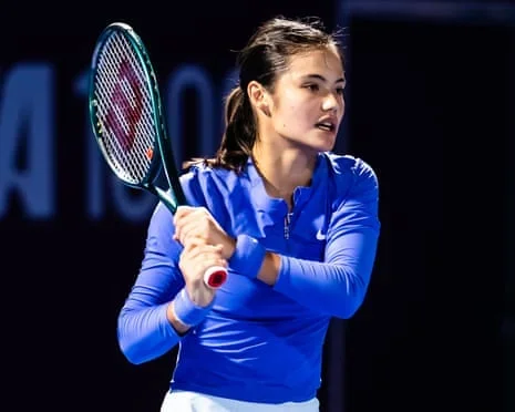 Emma Raducanu lifts her tennis racket